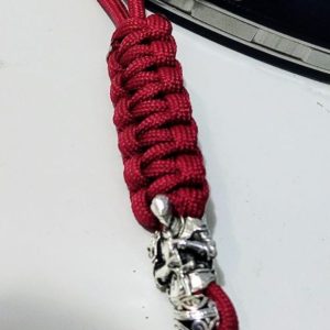 Folding knife with handmade red paracord braided lanyard – handcrafted EDC accessory from Choose.lv